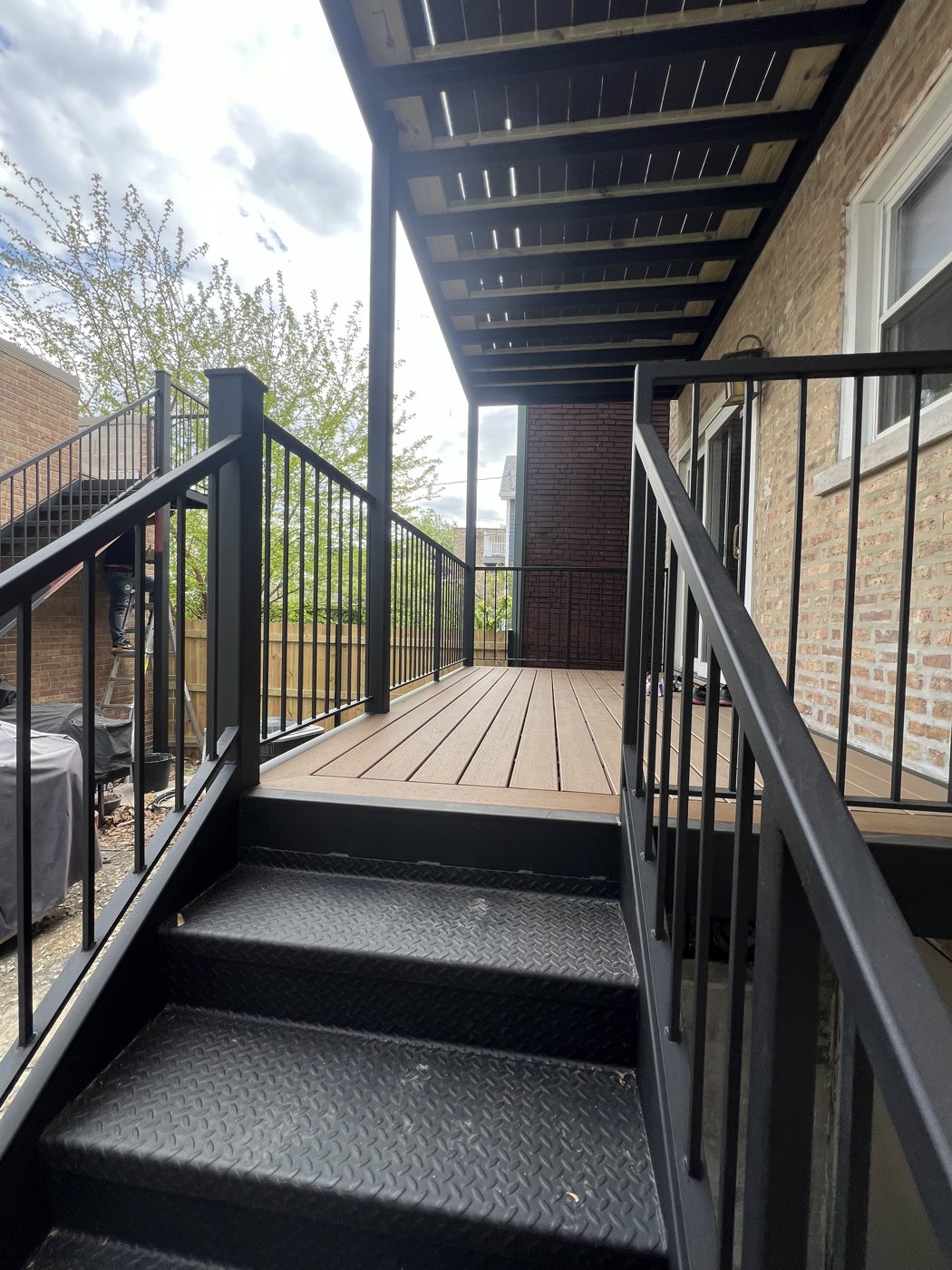 New deck stairs with steel railing and pergola